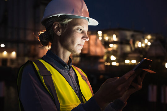 Female professional using digital tablet at night