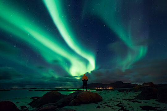 Norway, Lofoten Islands, Eggum, man admiring northern lights