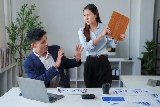 Female manager engaging in workplace harassment, threatening a male employee with a clipboard during a heated office argument, symbolizing bullying and a toxic work environment