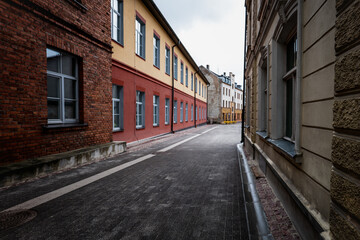 Fototapeta premium Empty Rainy Old Town Street Between Historic Buildings