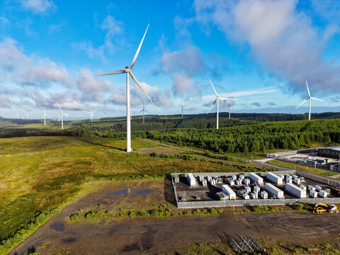 BESS Battery Storage System near Wind Farm Storing Renewable Energy.