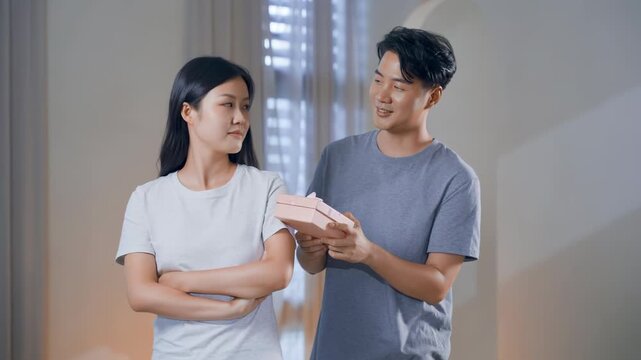 Romantic happy couple celebrating special occasion at home, loving man giving wrapped gift box to his happy wife girlfriend emotions for memories relationship celebration special occasion
