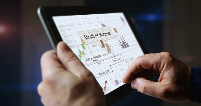 Strategic channels and straits for global trade charts and graphs diagram on touchscreen pad display. Finger touch tablet screen in hand. Digital analysis and report.