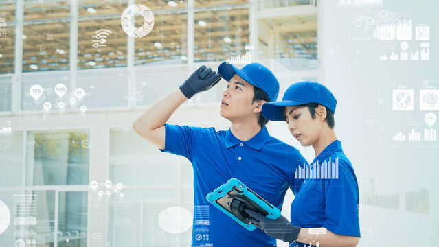 タブレットを使って建物を点検する作業員と測量データ