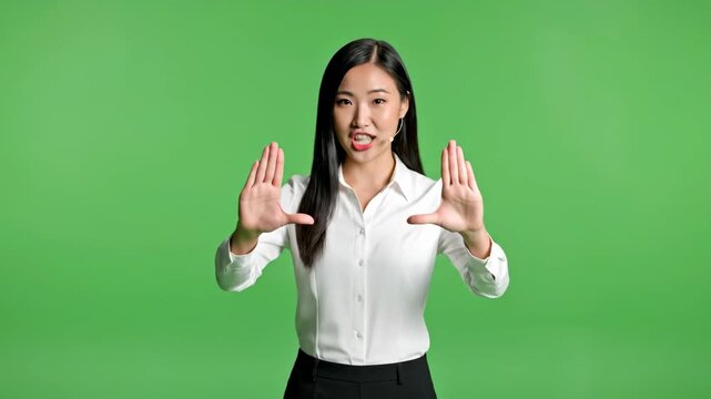 Asian businesswoman presenting with hand gestures on green screen for corporate communication and digital marketing