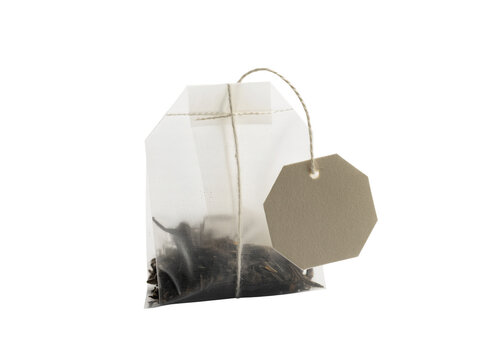 Transparent pyramid sachet containing natural loose leaf tea, neatly packaged with a blank tag and string, poised for steeping a refreshing and comforting hot beverage on a pristine white background