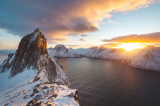Snowy Segla peak on Senja, Norway, at winter sunset, with pink clouds
