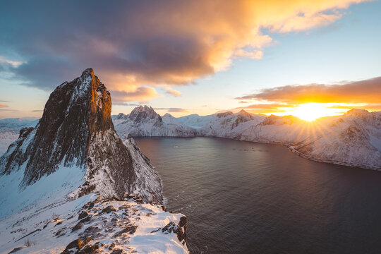 Snowy Segla peak on Senja, Norway, at winter sunset, with pink clouds