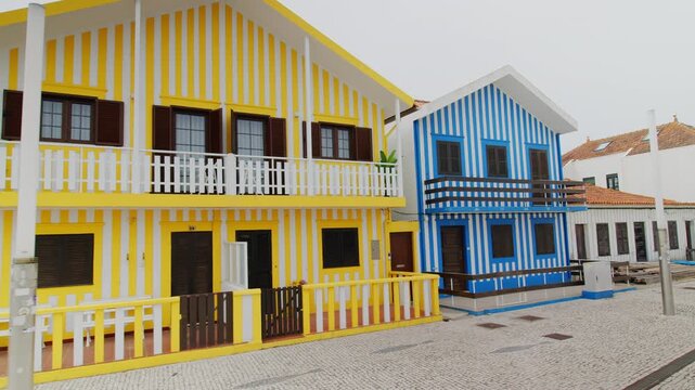 A slow panning shot showing the famous traditional colorful striped houses on the coast of Costa Nova, Aveiro in Portugal. 24.05.2026
