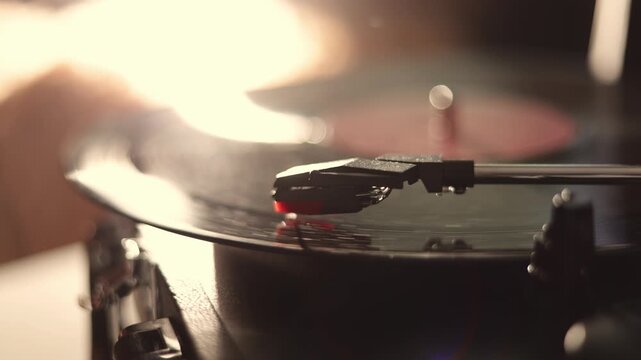 Close-up of a vintage record player needle tracking the grooves of a spinning vinyl disc