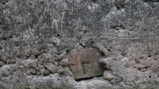 Close-Up of Weathered Concrete Wall Texture with Exposed Aggregate Detail