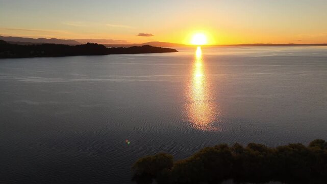 Aerial view of Villarrica Lake at sunset, golden reflection, Pucon, Chile.