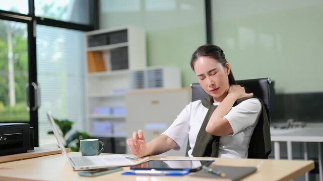 Focused businesswoman sorting documents at a cluttered desk with reports, coffee cups, and files. Perfect for accounting, finance, tax season, and deadline stress concepts.