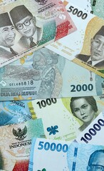 Indonesian rupiah money banknotes pile on table. Indonesia bills of IDR currency close up © Larysa