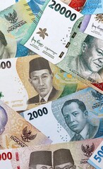 Indonesian rupiah money banknotes pile on table. Indonesia bills of IDR currency close up © Larysa