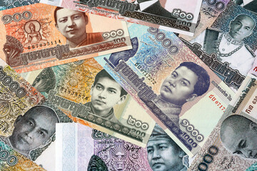 Cambodian riel money bills in pile on table. Cambodia KHR currency cash close up © Viktor