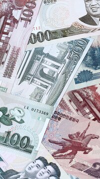 North Korean won money bills in pile on table. North Korea KPW currency cash close up