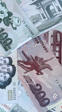 North Korean won money bills in pile on table. North Korea KPW currency cash close up