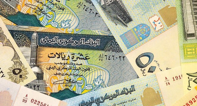 Yemeni rial money bills in pile on table. Yemen YER currency cash close up