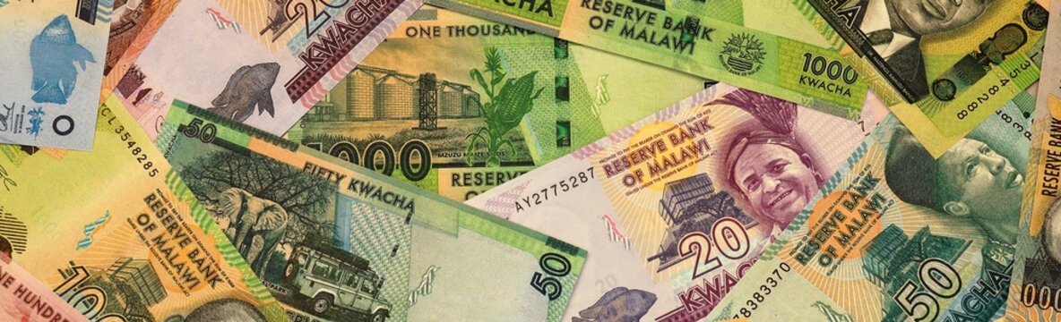 Malawian kwacha money bills in pile on table. Malawi MWK currency cash close up