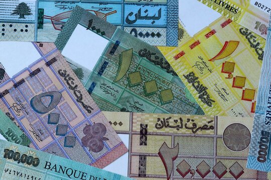 Lebanese pound money bills in pile on table. Lebanon LBP currency cash close up