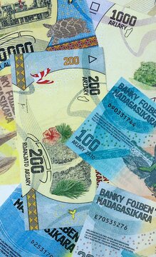 Malagasy ariary money bills in pile on table. Madagascar MGA currency cash close up