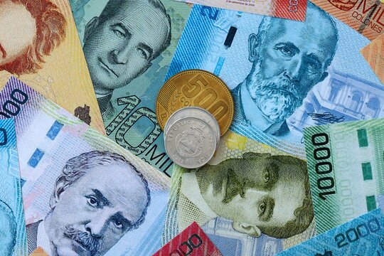Costa Rican colon money banknotes and coins on table. Costa Rica cash bills of CRC currency
