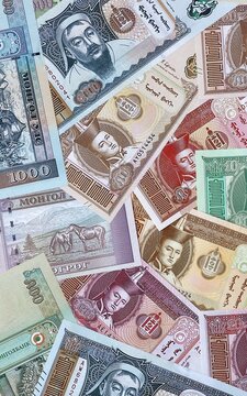 Mongolian tugrik money bills in pile. Big amount of Mongolia MNT currency cash close up