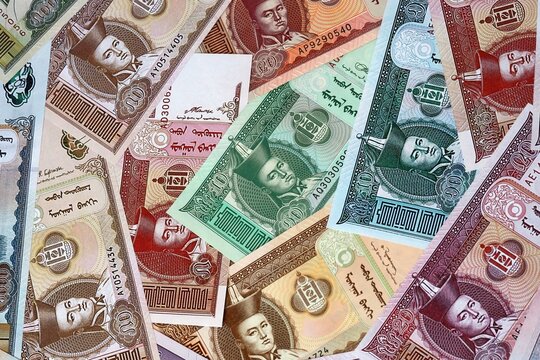 Mongolian tugrik money bills in pile. Big amount of Mongolia MNT currency cash close up