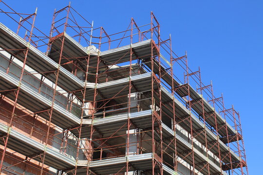 Lavori in corso nel cantiere edile in estate - gru e ponteggio	