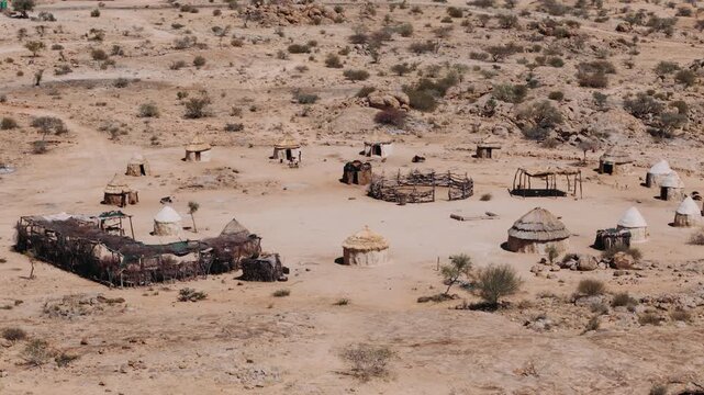 Traditional himba village with huts and kraal in the namibian desert near spitzkoppe from a Aerial view
