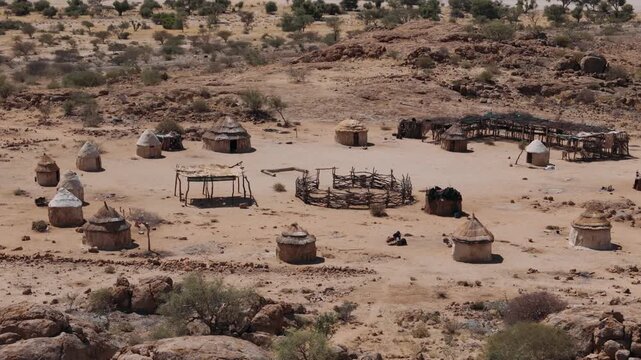 Traditional himba village with huts made of wood and clay near spitzkoppe in the namib desert, namibia