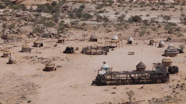 Aerial view of a traditional himba village with huts and a kraal in the remote desert, near spitzkoppe, namibia