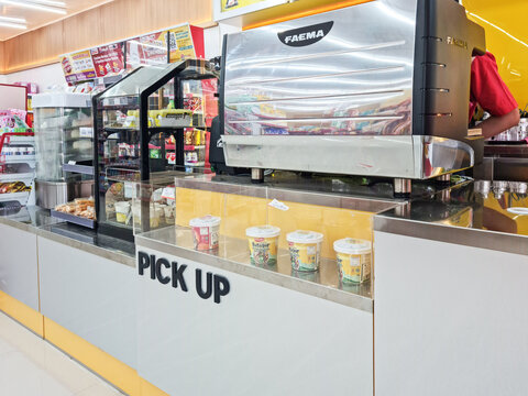 Beji, Depok - Indonesia, April 01 2026: Faema Espresso Machine and Food Pick Up Counter at Alfamart Convenience Store