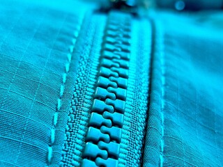 Macro shot of a bright blue plastic zipper © Fitri