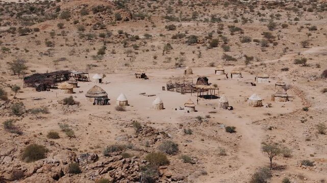 Himba village with traditional huts and houses in the arid landscape of spitzkoppe, namibia. Aerial view of an african settlement