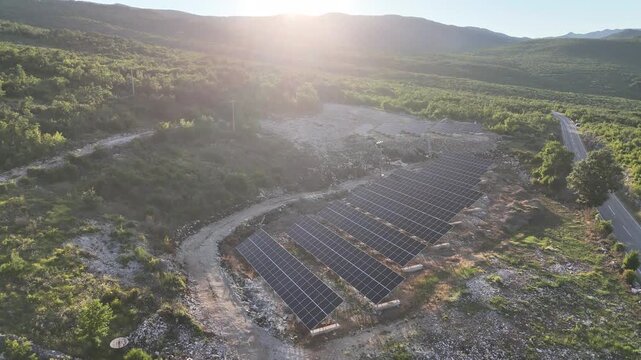 A beautiful aerial drone shot of a small-scale, community solar farm nestled within a rural landscape