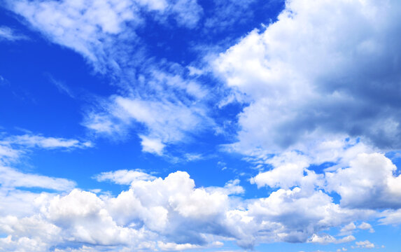 White clouds in the blue sky. Beautiful nature landscape. The azure expanse of the sky is adorned with pristine white clouds, creating a picturesque natural scene