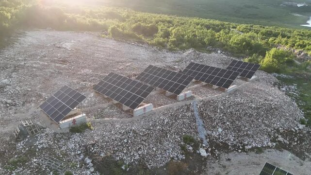 A beautiful aerial drone shot of a small-scale, community solar farm nestled within a rural landscape