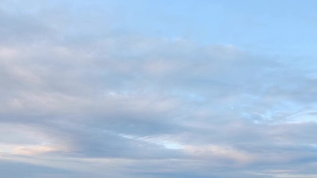 Expansive sky with soft, fluffy clouds transitioning from light to dark shades. A serene backdrop for nature, tranquility, and inspiration