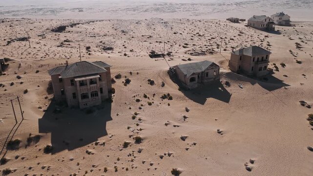 Abandoned kolmanskop ghost town being reclaimed by the namib desert sand, drone view