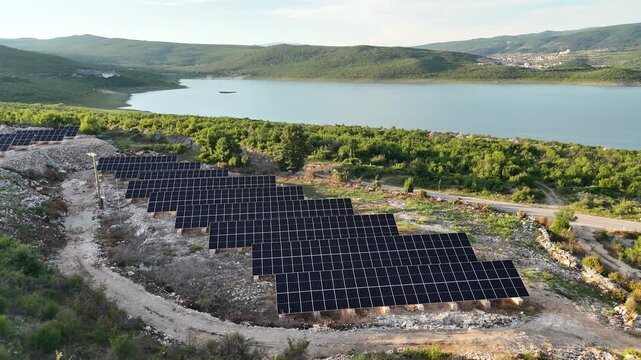 A beautiful aerial drone shot of a small-scale, localized solar farm situated within a rural landscape