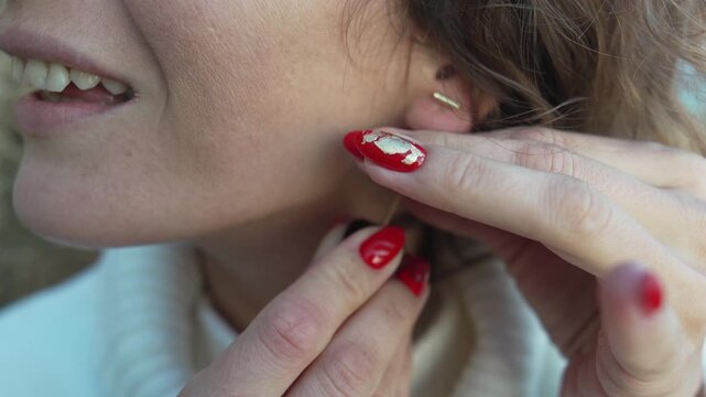 Earrings jewelry woman, putting on elegant handmade accessories, adjusting beaded ornaments.