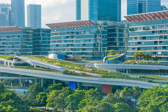 Contemporary mixed-use development with green roofs, landscaped terraces and modern office buildings in Shenzhen city, Guangdong Province, China. Sustainable urban design and eco-friendly architecture