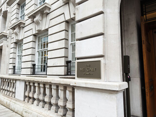 Naklejka premium Elegant stone hotel facade with entrance sign The Metcalf at St James, London, UK
