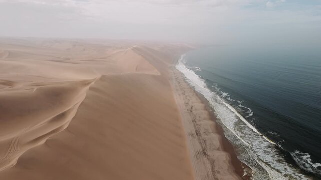 Aerial view of sandwich harbour where the namib desert dunes meet the atlantic ocean in namibia, africa