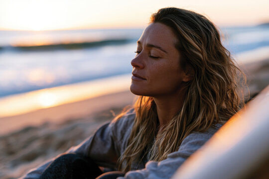 A contemplative surfer sits at the shore with eyes closed, appreciating the sounds of the waves and the warmth of the setting sun, embodying a sense of calm and connection.