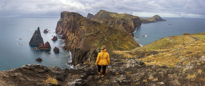 Hiker, coastal landscape, cliffs and sea, Miradouro da Ponta do Rosto, rugged coastline with rock formations, Cape Ponta de S&atilde;o Louren&ccedil;o, Madeira, Portugal