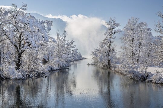Winter landscape with outflow of the Loisach from the Lake Kochel in front of the Herzogstand 1731m, Kochel am See, Das Blaue Land, Bavarian Alps, Upper Bavaria. Bavaria, Germany