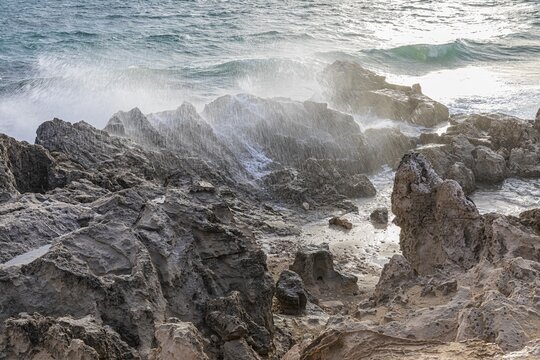 Sea water lashes over the eroded rocks on Salines beach, Ibiza, Balearic Islands, Mediterranean Sea, Spain